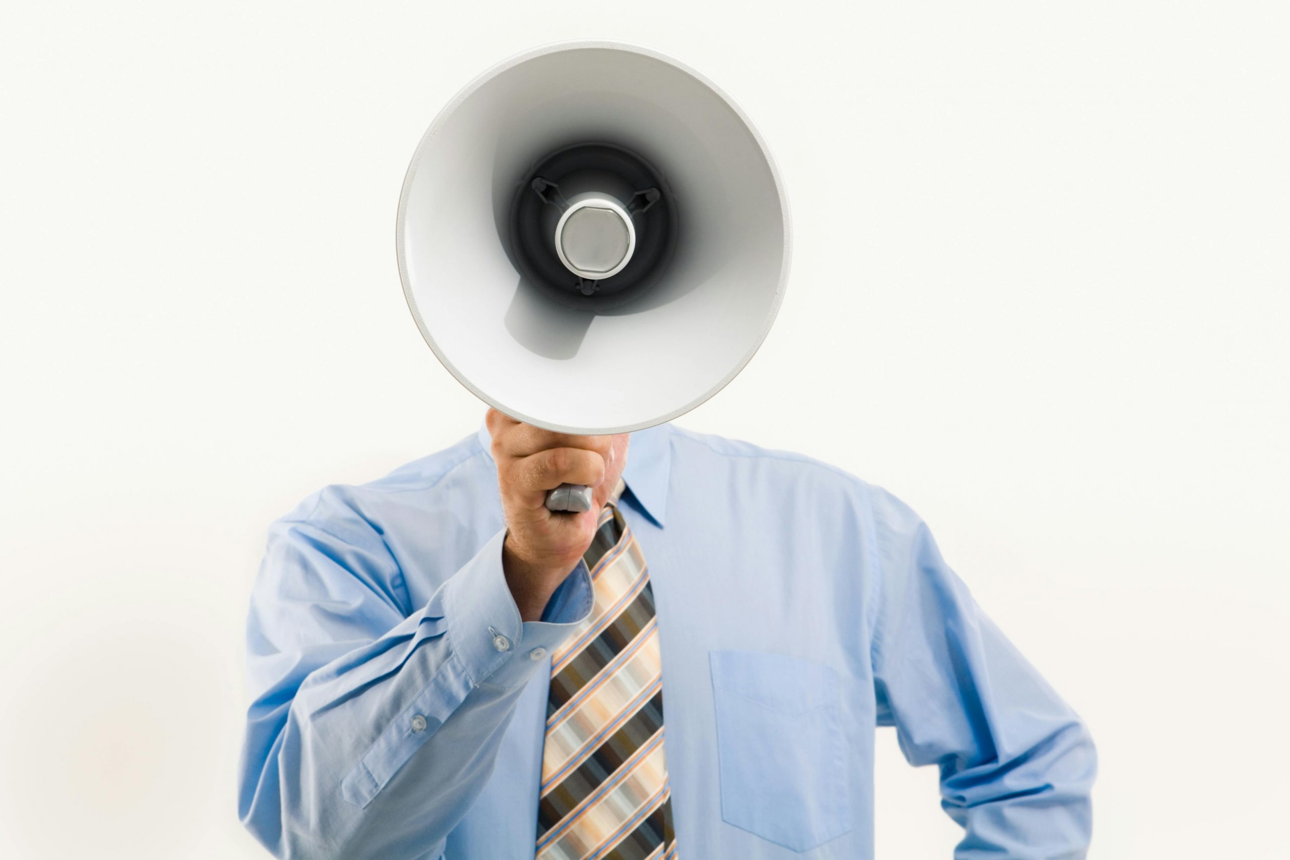Man in blue shirt holding a megaphone.
